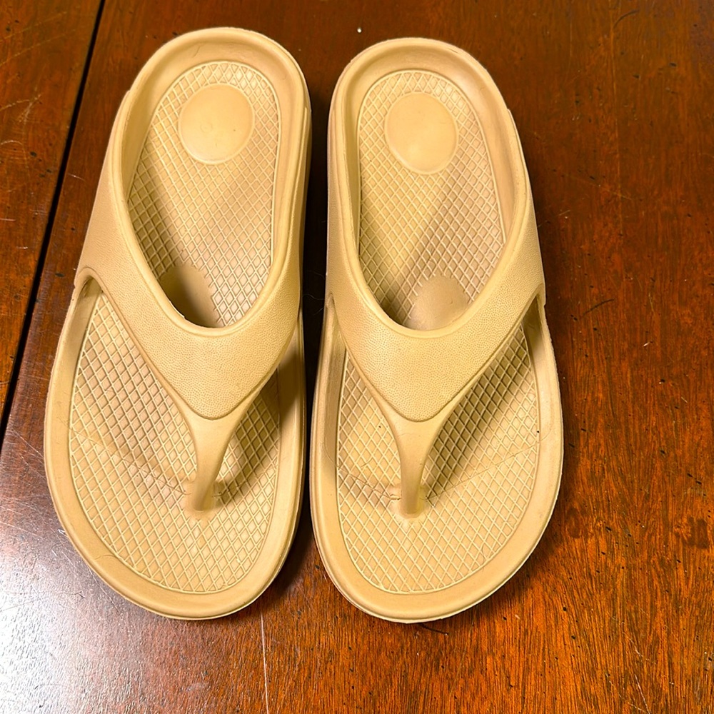 Tan flip flops